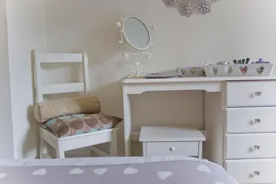 a bedroom with a desk and a chair and a mirror at Ty Mawr Hotel in Llanbedr