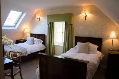 a hotel room with two beds and a window at The Lion in Leintwardine