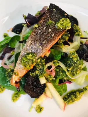 a plate of food with a fish and broccoli at The Lion in Leintwardine