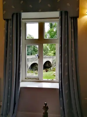 a window with a view of a bridge at The Lion in Leintwardine