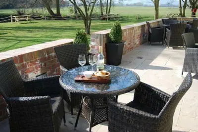 a table with glasses of wine on a patio at The Lion in Leintwardine