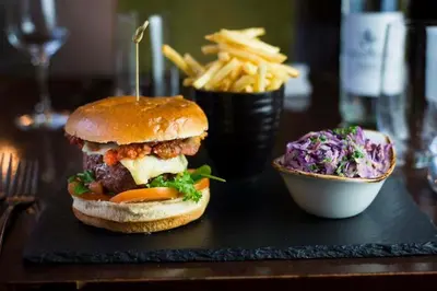 a sandwich and a side of fries on a table at The Lion in Leintwardine
