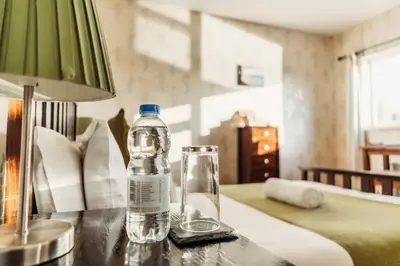 a bottle of water sitting on a table in a bedroom at Three Wells B&B in Llandrindod Wells