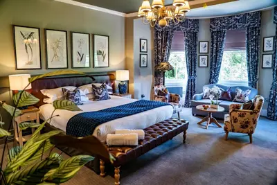 a bedroom with a large bed and a couch at Mytton and Mermaid - Brunning and Price in Shrewsbury