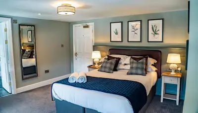 a bedroom with a large bed with two pillows at Mytton and Mermaid - Brunning and Price in Shrewsbury