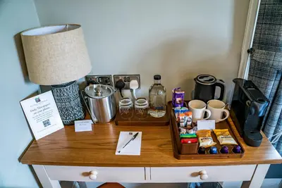a table with a coffee maker and a lamp on it at Mytton and Mermaid - Brunning and Price in Shrewsbury