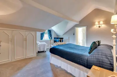 a bedroom with a large bed in a room at Tyddyn Llan Restaurant with Rooms in Corwen