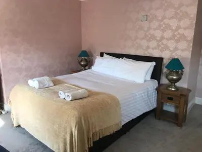 a bedroom with a bed with two towels on it at Aberystwyth, Pentre Farmhouse, in Capel Bangor