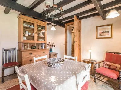 a dining room with a table and chairs at Hillgate House in Bromlow