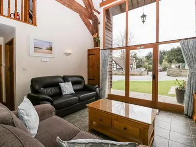 a living room with a leather couch and a table at Tippets View in Pembridge
