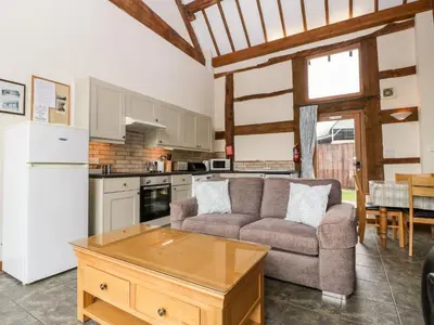a kitchen and living room with a couch and a table at Tippets View in Pembridge