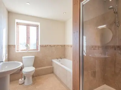 a bathroom with a toilet and a sink and a shower at Glebe Barn in Caynham