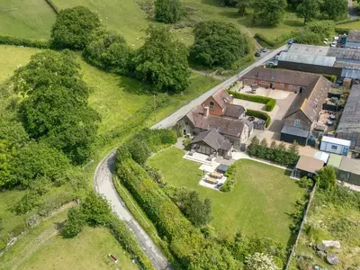 an aerial view of a house with a road at The Olde Cowshed in Acton Scott