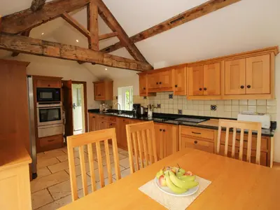 a kitchen with a table with a bowl of fruit on it at Old Coach House in Shrawardine