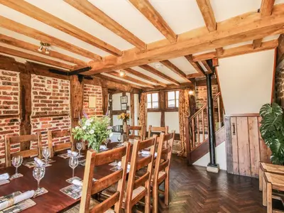 a dining room with a wooden table and chairs at The Olde Cow House in Hughley