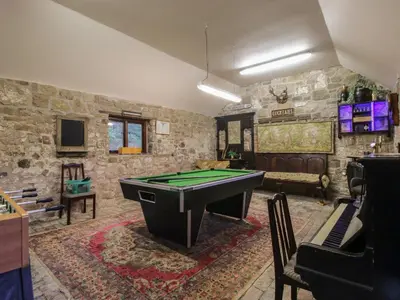 a living room with a pool table in a room at The Olde Cow House in Hughley