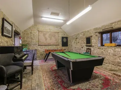 a billiard room with a pool table in it at The Olde Cow House in Hughley