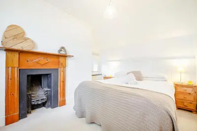 a bedroom with a bed and a fireplace at Braich-Y-Celyn Lodge in Aberdyfi