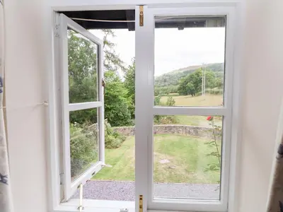 an open window with a view of a field at Bryn Howell Stables in Trevor