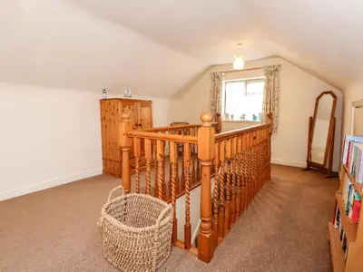 a room with a spiral staircase and a window at Brynteg in Llwyngwril