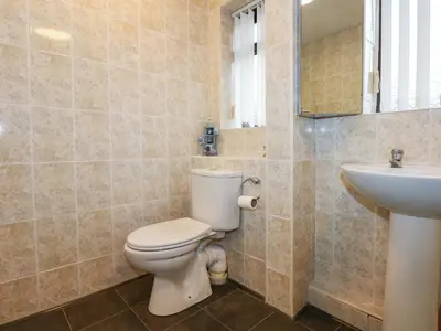 a bathroom with a toilet and a sink at Brynteg in Llwyngwril