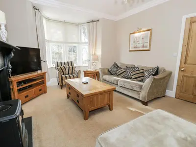 a living room with a couch and a coffee table at Tyddyn Goronwy in Dyffryn