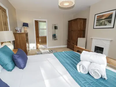 a bedroom with a large bed with towels on it at Tyddyn Goronwy in Dyffryn