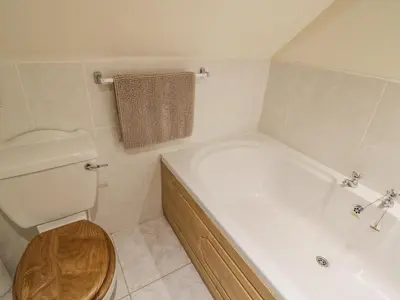 a bathroom with a tub and a toilet and a sink at Betty's Barn in Eaton