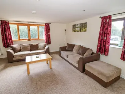 a living room with two couches and a coffee table at Betty's Barn in Eaton