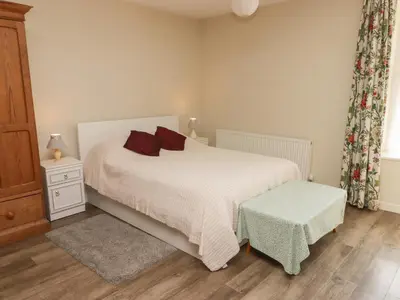 a bedroom with a white bed and a window at The School Room in Kington