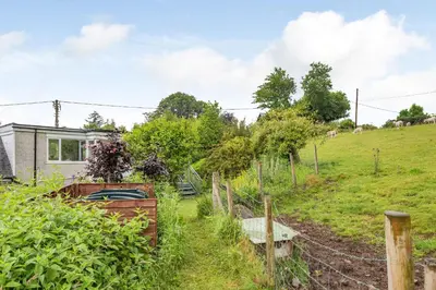 a house in a field with a fence at Penty in Dolgellau