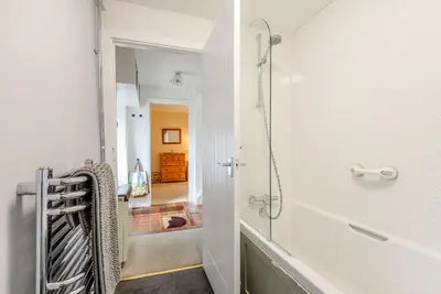 a bathroom with a walk in shower and a tub at Penty in Dolgellau