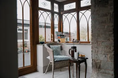 a room with a chair in front of a window at Stargazer's Loft in Clifford