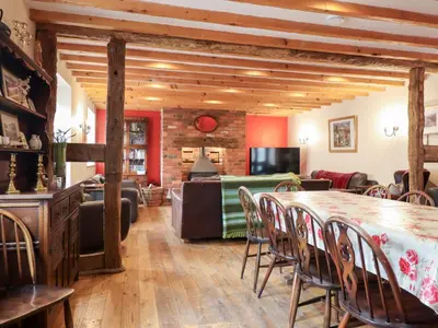 a living room with a table and a couch at Ysgubor Pwlliago in Pennant-Melangell