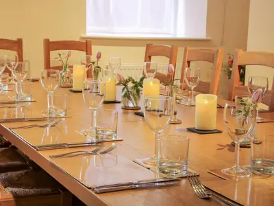 a long table with wine glasses and candles on it at The Maltster's House in Ludlow