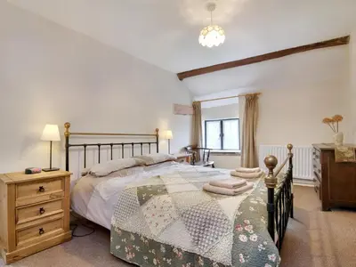 a bedroom with a bed and a dresser and a window at The Birches in Craswall