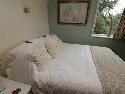 a bed with white sheets and pillows in a bedroom at Beacons Rest in Llanspyddid