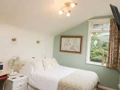 a bedroom with a bed and a window at Beacons Rest in Llanspyddid