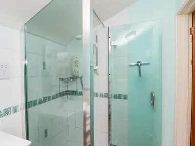 a shower with a glass door in a bathroom at Beacons Rest in Llanspyddid