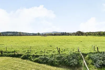a field of green grass with a fence at 2 Siluria Cottage in New Radnor