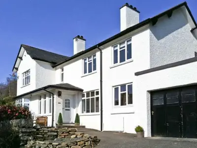 a large white house with a garage at Llechwedd in Dolgellau