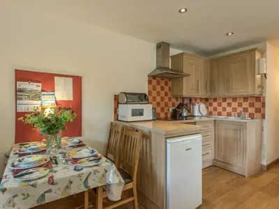 a kitchen with a table with plates on it at The Schoolhouse Bakehouse in Bishops Castle