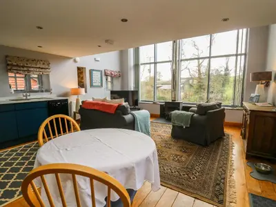 a living room with a table and chairs at The Barn at Glanoer in Bettws Disserth