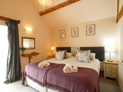 a bedroom with a bed with towels on it at Trooper's Barn in Acton Scott