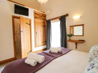a bedroom with a bed with two white towels at Trooper's Barn in Acton Scott