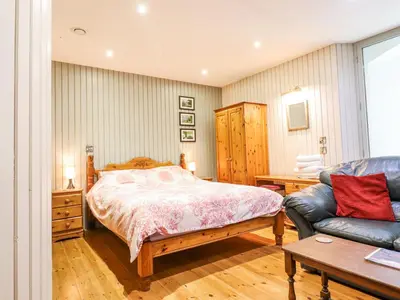 a bedroom with a bed and a couch at St Mary's in Tal-y-llyn