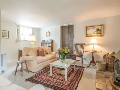 a living room with a couch and a table at Hope Hall Barn in Bromlow