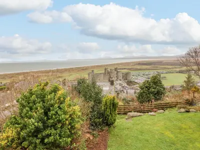 an old castle in the middle of a field at The Villa in Harlech