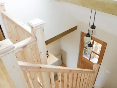 a wooden staircase in a house with a window at Bicton Lodge in Clun
