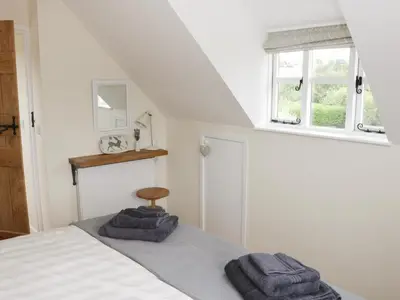 a bedroom with a bed with two towels on it at Bicton Lodge in Clun